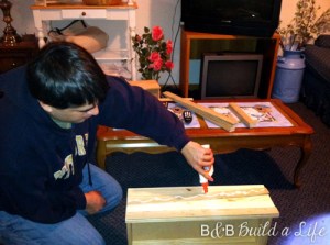 Bill gluing the lattice before adhering the pieces to the front of the drawers as well as the sides of the chest.